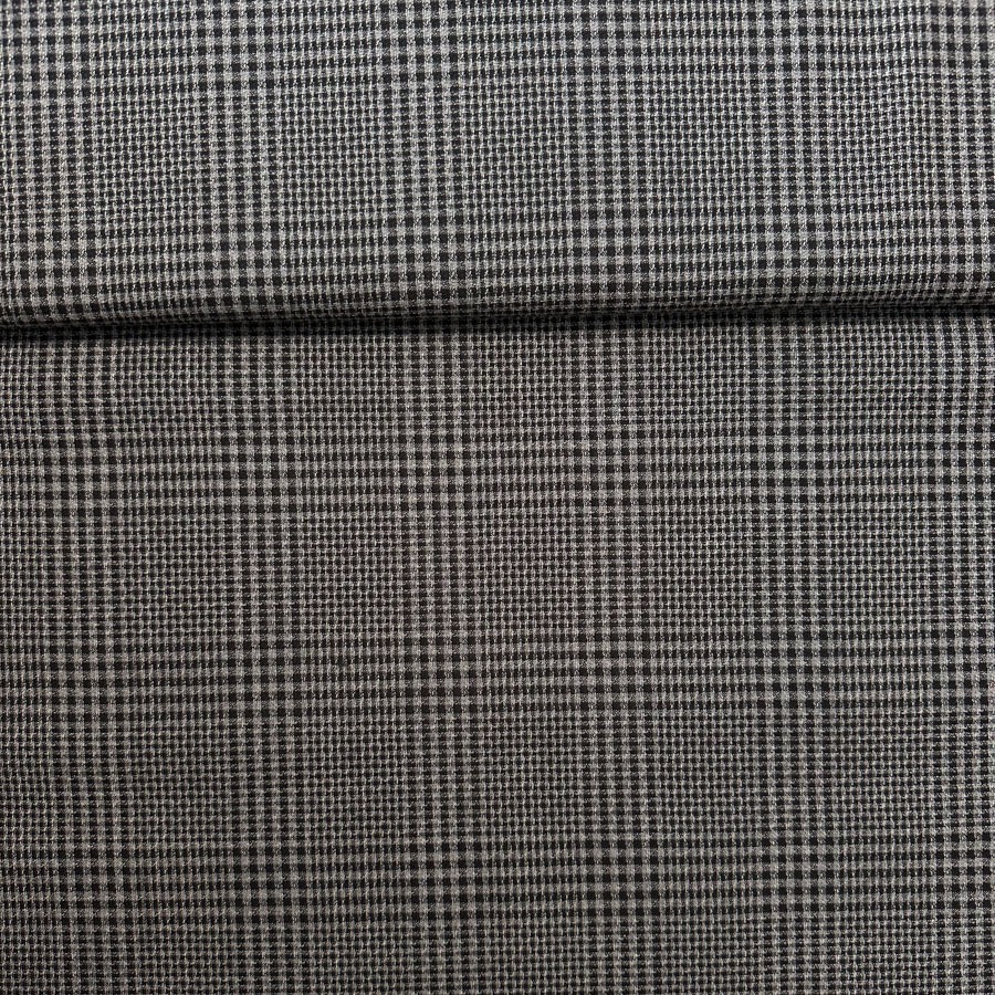 Villane musta-, halliruuduline kreppkostüümiriie. Laius 150cm